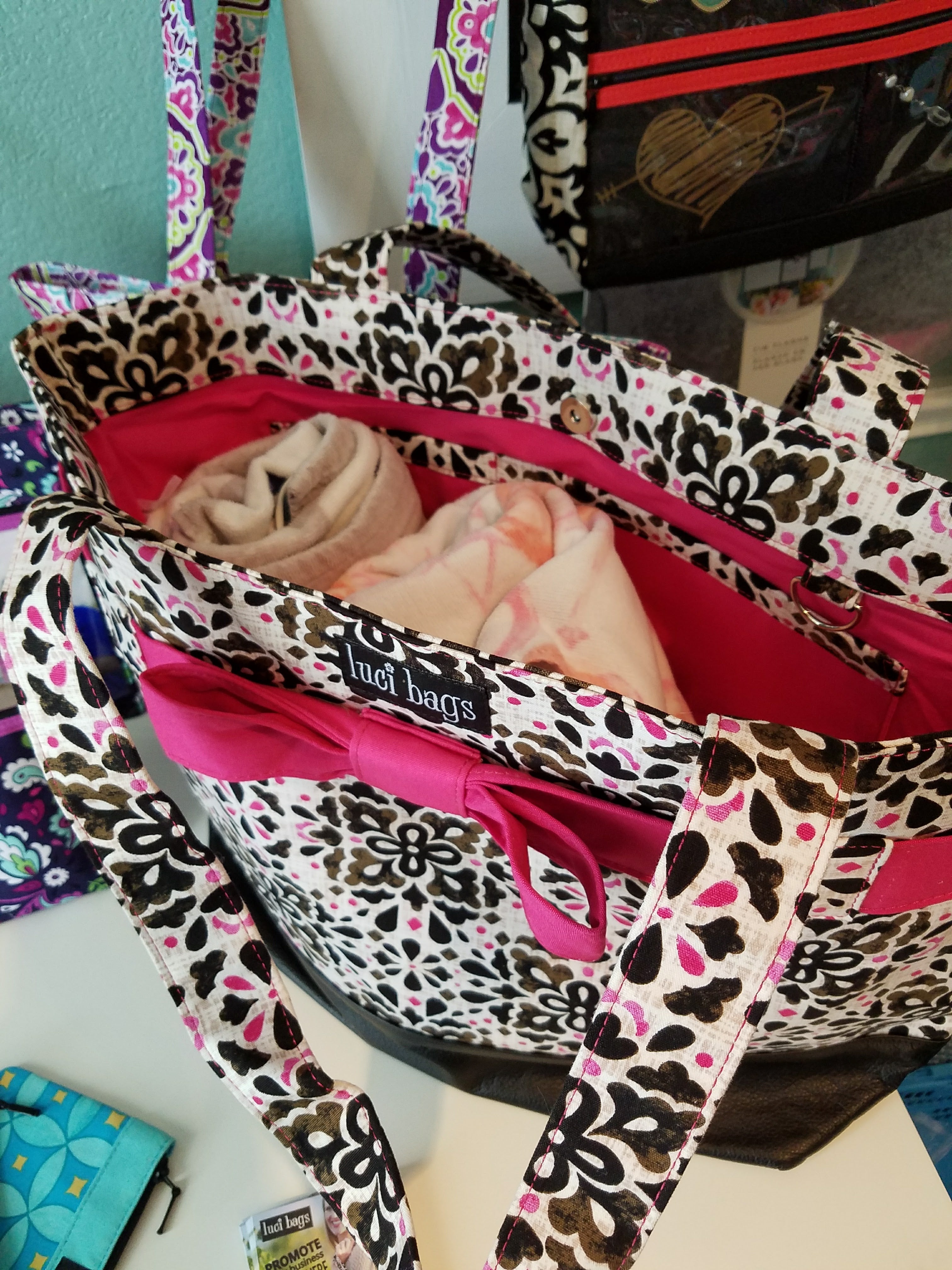 Black and white tote filled with baby blankets.